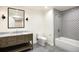 Modern bathroom featuring a marble countertop vanity and patterned tile shower and tub at 38 Sedgwick Dr, Cherry Hills Village, CO 80113