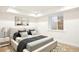 Cozy bedroom with a platform bed, modern art, and a window letting in natural light at 38 Sedgwick Dr, Cherry Hills Village, CO 80113
