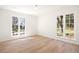 Bright bedroom with hardwood floors and large windows offering a view of the outdoors at 38 Sedgwick Dr, Cherry Hills Village, CO 80113