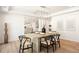 Bright dining area offers hardwood floors, modern chandelier, and flows into the kitchen, perfect for gatherings at 38 Sedgwick Dr, Cherry Hills Village, CO 80113