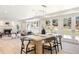Open-concept dining room showcases hardwood floors, a modern chandelier, and seamless access to living area at 38 Sedgwick Dr, Cherry Hills Village, CO 80113