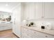 This kitchen features custom cabinets, marble countertops, and modern fixtures at 38 Sedgwick Dr, Cherry Hills Village, CO 80113