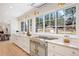 This kitchen features stainless appliances, marble counters, and a backyard view at 38 Sedgwick Dr, Cherry Hills Village, CO 80113
