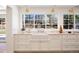 Bright kitchen featuring custom cabinetry, marble countertops, and stainless steel appliances at 38 Sedgwick Dr, Cherry Hills Village, CO 80113