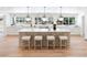 Bright kitchen features an oversized island with bar seating, ample countertops, and modern lighting, ideal for cooking at 38 Sedgwick Dr, Cherry Hills Village, CO 80113