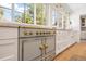 Modern kitchen featuring an oversized range, marble countertops, and ample storage space at 38 Sedgwick Dr, Cherry Hills Village, CO 80113