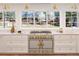 This kitchen features stainless appliances, marble counters, and a backyard view at 38 Sedgwick Dr, Cherry Hills Village, CO 80113