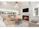 Inviting living room with a fireplace, open to a gourmet kitchen, and filled with natural light at 38 Sedgwick Dr, Cherry Hills Village, CO 80113