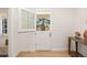 Mudroom features shiplap walls, hardwood floors and dutch door with view of yard at 38 Sedgwick Dr, Cherry Hills Village, CO 80113