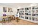 Bright home office with custom bookshelves, hardwood floors, and ample desk space at 38 Sedgwick Dr, Cherry Hills Village, CO 80113