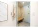 Shower featuring rain shower head, built-in bench and decorative tile at 38 Sedgwick Dr, Cherry Hills Village, CO 80113