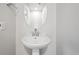 Bathroom featuring a pedestal sink, modern fixtures, and neutral color palette at 19079 E 94Th Pl, Commerce City, CO 80022