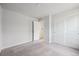 Clean bedroom featuring closet and door to another room, and neutral carpeting at 19079 E 94Th Pl, Commerce City, CO 80022