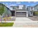 Two-story home featuring a two car garage, a mix of vertical and horizontal siding, and low maintenance landscaping at 19079 E 94Th Pl, Commerce City, CO 80022