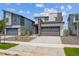 Modern townhome showcasing a two-car garage and manicured front yard at 19079 E 94Th Pl, Commerce City, CO 80022
