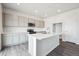 Bright kitchen with a large center island, stainless appliances and light cabinetry at 19079 E 94Th Pl, Commerce City, CO 80022
