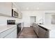 Modern kitchen featuring stainless steel appliances and light gray cabinetry at 19079 E 94Th Pl, Commerce City, CO 80022