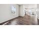 Bright, sun-lit room with gray wood floors and large windows at 19079 E 94Th Pl, Commerce City, CO 80022