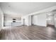 Open-concept living area with kitchen, stainless appliances, island, and hardwood floors at 19079 E 94Th Pl, Commerce City, CO 80022