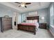 A spacious main bedroom with a ceiling fan, and ensuite bath, and is decorated in calm blues and whites at 23049 E Narrowleaf Dr, Aurora, CO 80016