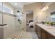 Modern bathroom showcasing a glass-enclosed shower and a peek into the main bedroom at 1079 Parkline Ln, Monument, CO 80132