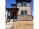 Charming two-story home with red front door, stone accents, and a covered porch at 5454 N Elk St, Aurora, CO 80019