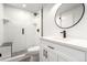 Modern bathroom with white subway tile, glass enclosed shower, and black fixtures at 720 16Th St # 207, Denver, CO 80202