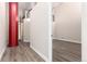 Hallway with gray flooring and a red support column leading to the next room at 720 16Th St # 207, Denver, CO 80202