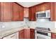 The renovated kitchen features stainless steel appliances, granite countertops and wooden cabinets at 720 16Th St # 207, Denver, CO 80202