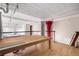 Second-story loft area showcasing exposed ceiling, red column, and natural light at 720 16Th St # 207, Denver, CO 80202