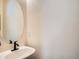 Close up of half bathroom's sink and oval mirror at 13638 Garfield St # C, Thornton, CO 80602