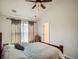 Bedroom featuring a wooden bed frame, neutral decor, ceiling fan, and natural light at 13638 Garfield St # C, Thornton, CO 80602