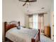 Bedroom showcasing a wooden bed frame, neutral decor, ceiling fan, and natural light at 13638 Garfield St # C, Thornton, CO 80602