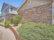 Beautifully landscaped home exterior with stone accents and a winding path at 13638 Garfield St # C, Thornton, CO 80602
