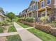 Street view showcasing the townhome exteriors with well-manicured lawns at 13638 Garfield St # C, Thornton, CO 80602