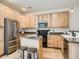 Well-equipped kitchen with stainless steel appliances and a center island with seating at 13638 Garfield St # C, Thornton, CO 80602