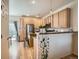 Modern kitchen with light wood cabinets, stainless steel appliances, and a breakfast bar at 13638 Garfield St # C, Thornton, CO 80602