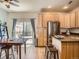 Eat-in kitchen featuring stainless steel refrigerator, access to a deck through sliding glass doors, and wood flooring at 13638 Garfield St # C, Thornton, CO 80602