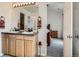 Main bathroom featuring a dual sink vanity, framed mirror, and linen closet at 13638 Garfield St # C, Thornton, CO 80602