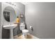 Cozy half bathroom featuring a pedestal sink and neutral gray walls, creating a clean and functional space at 6650 Stagecoach Ave, Firestone, CO 80504
