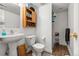 Functional bathroom featuring a pedestal sink, cabinet, and shower, designed for practicality and everyday use at 6650 Stagecoach Ave, Firestone, CO 80504