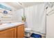 Functional bathroom with a single vanity, toilet, and shower curtain, designed for practicality and everyday use at 6650 Stagecoach Ave, Firestone, CO 80504