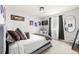 Inviting bedroom with neutral tones, featuring a comfortable bed, desk, and TV for relaxation and productivity at 6650 Stagecoach Ave, Firestone, CO 80504