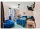 Cozy bedroom with a blue beanbag, TV, and ample space for relaxing and personalizing at 6650 Stagecoach Ave, Firestone, CO 80504
