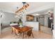 Open dining space with modern lighting and easy access to the living room and kitchen areas at 6650 Stagecoach Ave, Firestone, CO 80504
