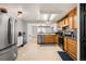 Functional kitchen features wood cabinets, stainless appliances, and seamless access to the dining room at 6650 Stagecoach Ave, Firestone, CO 80504