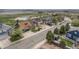 Aerial view of a neighborhood with a golf course and a pond nearby, showcasing the home's location at 2190 Coyote Creek Dr, Fort Lupton, CO 80621