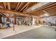 Spacious unfinished basement with exposed beams and utilities, offering potential for customization at 2190 Coyote Creek Dr, Fort Lupton, CO 80621