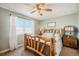 Comfortable bedroom with a large window offering plenty of natural light and a view of the outdoors at 2190 Coyote Creek Dr, Fort Lupton, CO 80621