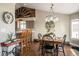 Inviting dining area featuring a wooden table, chandelier lighting, and views into the kitchen at 2190 Coyote Creek Dr, Fort Lupton, CO 80621